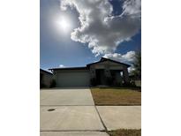 Charming single-story home featuring a two-car garage and stone pillar accents at 2082 Gold Dust Dr, Clermont, FL 34715