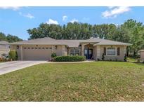 Charming single-story home with a well-manicured lawn and a two-car garage at 609 Westview Dr, Minneola, FL 34715