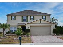 Charming two-story home features a well-manicured lawn and attached two-car garage at 7407 Country Run Pkwy, Orlando, FL 32818