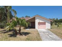 Charming single-story home featuring desert landscaping and a single-car garage at 857 E Flag Ln, Kissimmee, FL 34759