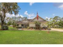Charming single-story home with a large front yard and an American flag at 10528 Old Dade City Rd, Lakeland, FL 33810