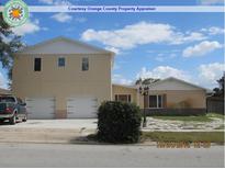 Two-story home featuring a spacious two-car garage and a well-maintained front yard in a suburban neighborhood at 1236 Russell Dr, Ocoee, FL 34761