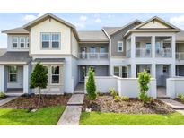 Inviting townhome showcases a modern exterior with a charming balcony and well-maintained landscaping at 14259 Kellogg Ave, Orlando, FL 32827