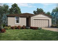 Charming single-story home featuring a lush front yard and a two-car garage at 2365 White Tail St, Davenport, FL 33837