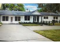 Charming single-story home with a well-manicured lawn and a spacious driveway at 245 W George Ave, Maitland, FL 32751