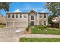 Charming two-story home with a well-manicured lawn and a three-car garage at 2658 Palmetto Ridge Cir, Apopka, FL 32712