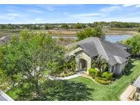 Beautiful exterior view of home, lush lawn, mature trees, and picturesque landscaping at 27127 Stoney Brook Dr, Leesburg, FL 34748