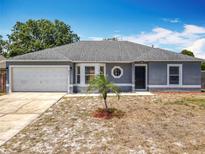 Charming one-story home featuring a new roof, attached garage, and decorative circular window at 2818 Irondale St, Deltona, FL 32738