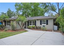 Charming single-story home featuring a well-manicured lawn and a long driveway at 3204 Amherst Ave, Orlando, FL 32804