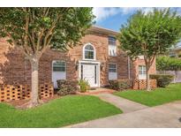 Charming brick townhouse with manicured lawn and mature trees at 4262 Lake Underhill Rd # 9C7, Orlando, FL 32803