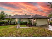 Charming single-story home with lush landscaping and a neatly manicured green lawn, perfect curb appeal at 789 Barger Dr, Deltona, FL 32738