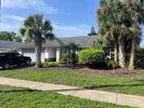 Single story home featuring lush landscaping and mature palms in a peaceful neighborhood at 826 Bright Meadow Dr, Lake Mary, FL 32746