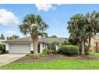 Charming single-story home with a well-manicured lawn, mature palm trees, and a two-car garage at 826 Bright Meadow Dr, Lake Mary, FL 32746