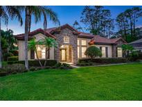 Stunning stone and stucco home with a tile roof and lush landscaping at 914 Sweetgum Valley Pl, Lake Mary, FL 32746