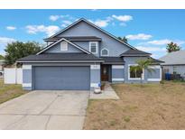 Charming two-story home with a well-maintained lawn and attached two-car garage at 1010 Sugarberry Trl, Oviedo, FL 32765