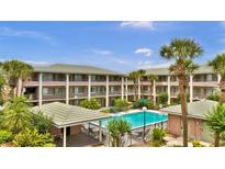 Beautiful condo complex featuring a refreshing swimming pool surrounded by lush landscaping at 115 Oyster Bay Cir # 260, Altamonte Springs, FL 32701