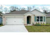 Charming single-story home with a two-car garage, well-maintained lawn, and neutral color palette at 1315 Lawndale Cp, Ormond Beach, FL 32174