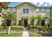 Inviting townhome exterior featuring well-maintained landscaping and charming curb appeal at 13329 Harbor Shore Ln, Winter Garden, FL 34787