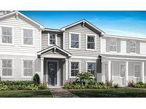 Charming new construction home with a classic design, inviting entrance, and lush landscaping at 3173 Douglas Fir Dr, Apopka, FL 32703