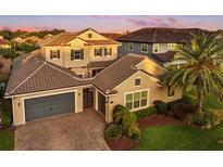 A well-manicured home displays a tiled roof, a spacious three-car garage, and brick paver driveway at 3647 Farm Bell Pl, Lake Mary, FL 32746