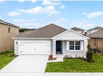Charming single-story home with a well-manicured lawn, two car garage and inviting front entrance at 5210 Marshelder, Apopka, FL 32712