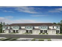 New townhome exteriors showcasing covered entries, single car garages, and beautifully landscaped front yards at 7751 Waterscape Dr, Groveland, FL 34736