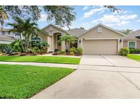 Charming home with well-manicured lawn and lush landscaping at 10222 Marsh Pine Cir, Orlando, FL 32832