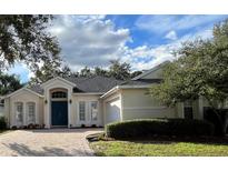 Charming single-story home with a blue door and lush landscaping at 1432 Stargazer Ter, Sanford, FL 32771