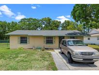 Charming single-story home with a well-maintained lawn and colorful exterior accents at 2213 Bates Ave, Eustis, FL 32726