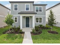 Charming two-story home with gray siding, well-manicured landscaping, and inviting front entrance at 2467 Zuni Road, St Cloud, FL 34771