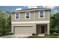 Charming two-story home with a two-car garage and covered entryway, perfect for a growing Gathering at 4622 Snapdragon Pl, Lake Hamilton, FL 33851