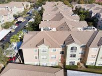 An aerial view of an apartment complex showing the building's roofs and parking areas at 4833 Cypress Woods Dr # 4101, Orlando, FL 32811