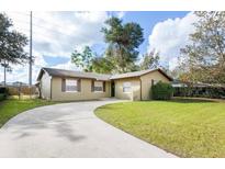 Charming single-story home with a well-maintained front yard and a long, curved driveway at 631 Trailwood Dr, Altamonte Springs, FL 32714