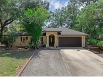 Charming single-story home featuring a well-manicured front yard and attached two-car garage at 670 N Sparkman Ave, Orange City, FL 32763