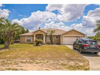 Charming single-Gathering home featuring a two-car garage and a well-manicured lawn at 10585 Sw 38Th Ave, Ocala, FL 34476