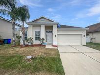 Charming single-story home with a well-maintained lawn and a two-car garage at 1123 Hacienda Cir, Kissimmee, FL 34741