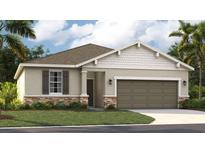 Charming single-Gathering home features a stone accent facade, two-car garage and well-manicured lawn at 1219 Normandy Dr, Haines City, FL 33844