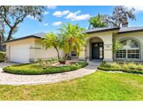 Beautiful home featuring well-manicured landscaping and a covered front entryway at 169 Winding Oaks Ln, Oviedo, FL 32765
