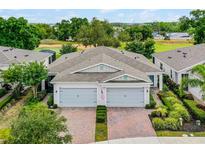 Beautiful paired villas with meticulously landscaped front yard, and two-car garage each at 1855 Flora Pass Pl, Kissimmee, FL 34747