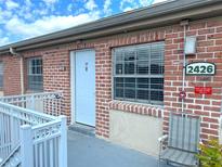 Brick condo with white door and trim, featuring updated windows and convenient access at 2426 Branch Way # 200, Maitland, FL 32751