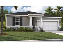 Charming one-story home with a gray exterior, dark shutters and an attached two-car garage at 398 Eventide Ave, Mascotte, FL 34753