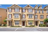 Beautiful three story townhomes featuring decorative shutters, landscaping, and convenient parking spaces at 628 Pensacola Ln # 628, Lake Mary, FL 32746