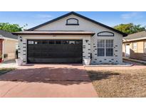 Charming single-story home featuring a two-car garage and nicely painted exterior at 9911 Dean Cove Ln, Orlando, FL 32825
