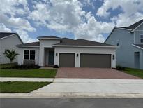 Modern single-story home featuring a two-car garage and well-maintained landscaping at 1016 Gloryland Ct, Sanford, FL 32771