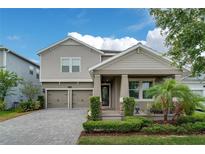 Charming two-story home with a well-manicured lawn and a two-car garage on a beautiful sunny day at 11456 Short Story St, Orlando, FL 32832