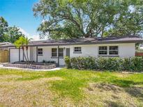 Charming single story home featuring lush landscaping and fresh exterior paint at 1298 Scottsdale Dr, Ormond Beach, FL 32174
