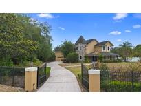 Stunning two-story home with a beautiful turret and well-manicured front yard at 1415 Brumley Rd, Chuluota, FL 32766