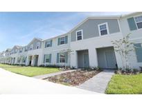 Charming townhomes feature two-story construction with landscaped lawns, sidewalks, and individual entrances at 197 Jetty Way, Davenport, FL 33897