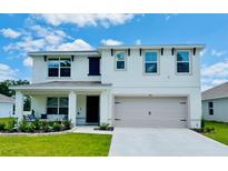 Charming two-story home with a well-manicured lawn and covered front porch at 239 Se 66Th Ct, Ocala, FL 34472