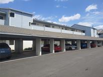 Exterior view of the covered parking area under a light blue, multi-story building at 4109 Fairview Vista Pt # 315, Orlando, FL 32804